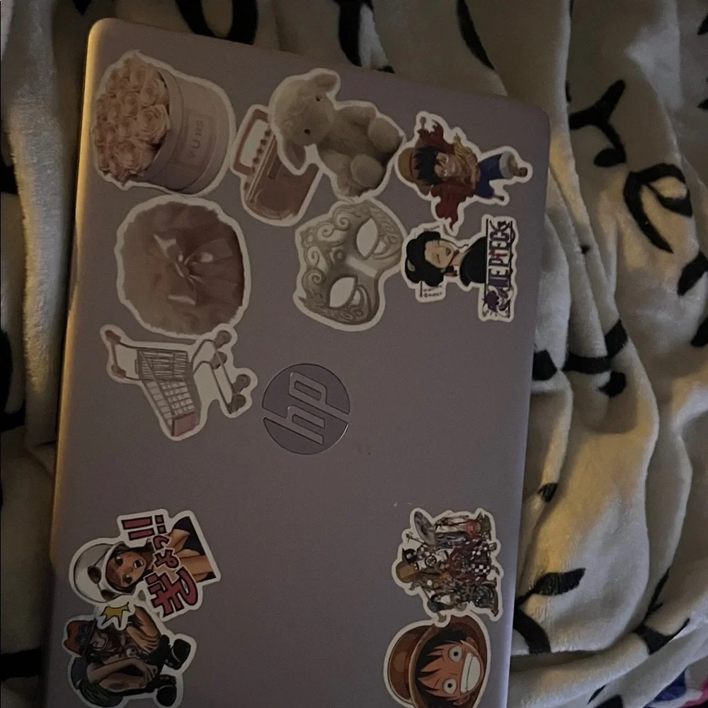 HP Laptop with Anime and Floral Stickers